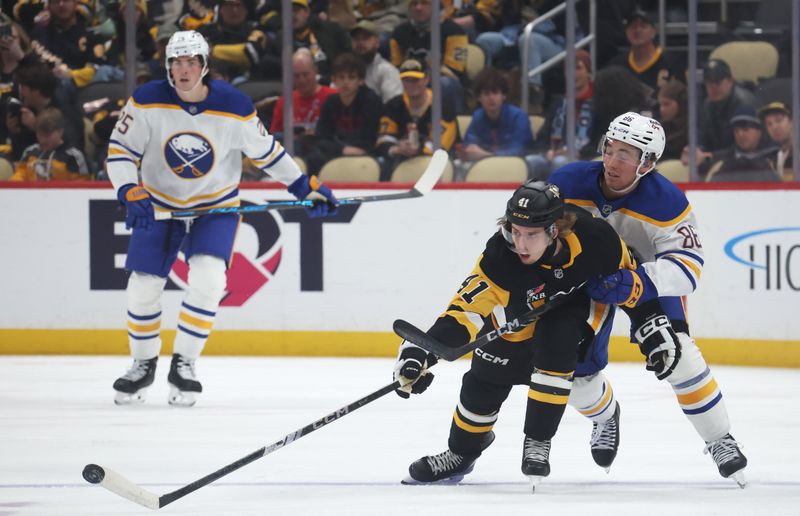 Nov 26, 2025; Pittsburgh, Pennsylvania, USA;  Pittsburgh Penguins right wing Ville Koivunen (41) moves the puck away from Buffalo Sabres center Noah Ostlund (86) during the second period at PPG Paints Arena. Mandatory Credit: Charles LeClaire-Imagn Images