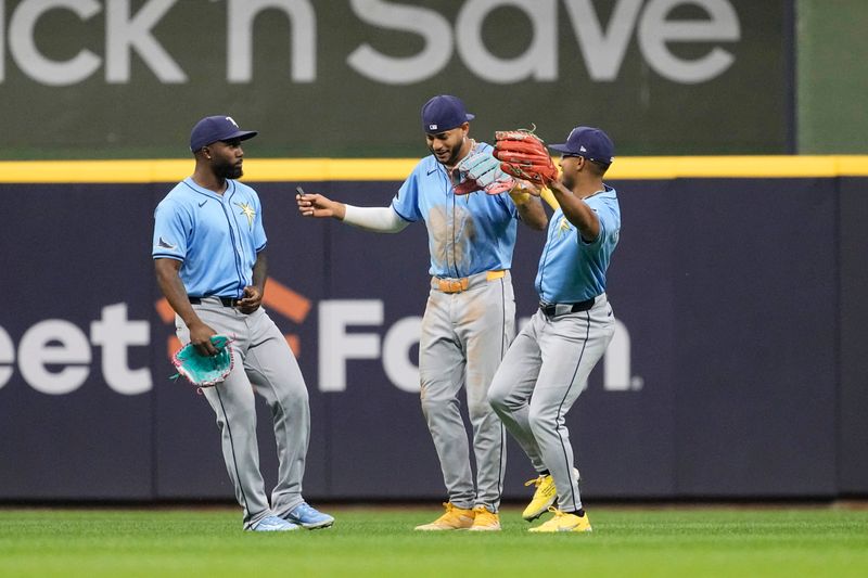 Apr 29, 2024; Milwaukee, Wisconsin, USA;  Tampa Bay Rays outfielders celebrate following the game against the Milwaukee Brewers at American Family Field. Mandatory Credit: Jeff Hanisch-USA TODAY Sports