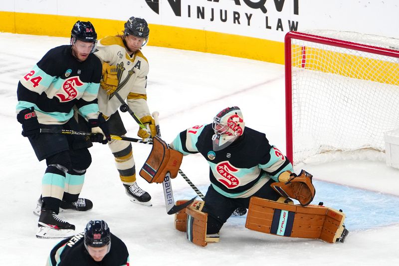 Mar 21, 2024; Las Vegas, Nevada, USA; Seattle Kraken goaltender Philipp Grubauer (31) makes a save against the Vegas Golden Knights as Seattle Kraken defenseman Jamie Oleksiak (24) fends off Vegas Golden Knights center William Karlsson (71) during the first period at T-Mobile Arena. Mandatory Credit: Stephen R. Sylvanie-USA TODAY Sports