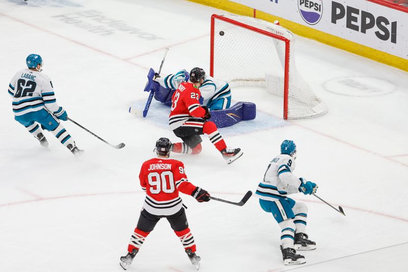 Mar 17, 2024; Chicago, Illinois, USA; Chicago Blackhawks center Philipp Kurashev (23) scores against the San Jose Sharks during the second period at United Center. Mandatory Credit: Kamil Krzaczynski-USA TODAY Sports