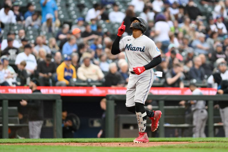 Jun 14, 2023; Seattle, Washington, USA; Miami Marlins designated hitter Jorge Soler (12) crosses home plate after hitting a home run against the Seattle Mariners during the sixth inning at T-Mobile Park. Mandatory Credit: Steven Bisig-USA TODAY Sports