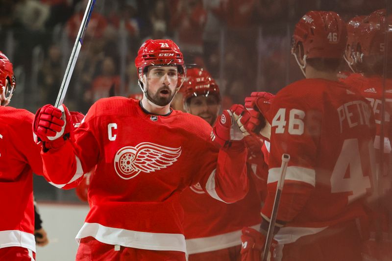 Jan 13, 2024; Detroit, Michigan, USA;  Detroit Red Wings center Dylan Larkin (71) receives congratulations from teammates after scoring in the first period against the Los Angeles Kings at Little Caesars Arena. Mandatory Credit: Rick Osentoski-USA TODAY Sports