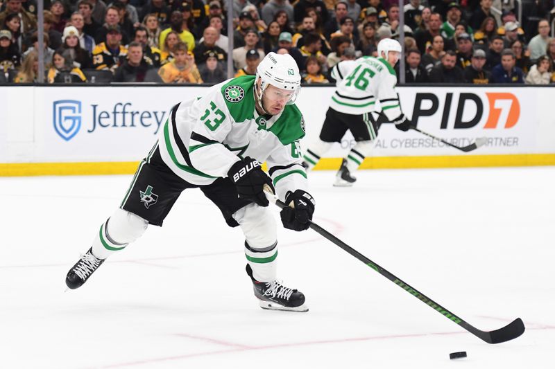 Oct 24, 2024; Boston, Massachusetts, USA;  Dallas Stars right wing Evgenii Dadonov (63) tries to gain control of the puck during the second period against the Boston Bruins at TD Garden. Mandatory Credit: Bob DeChiara-Imagn Images