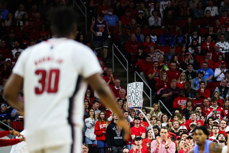 Feb 19, 2023; Raleigh, North Carolina, USA; A North Carolina State Wolfpack forward D.J. Burns Jr. (30) fan sign seen during the second half of the game against North Carolina Tar Heels at PNC Arena. Mandatory Credit: Jaylynn Nash-USA TODAY Sports