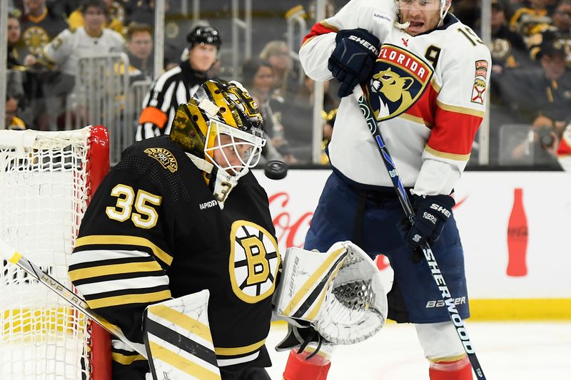 Apr 6, 2024; Boston, Massachusetts, USA; Boston Bruins goaltender Linus Ullmark (35) watches the puck while Florida Panthers left wing Matthew Tkachuk (19) looks for a rebound during the second period at TD Garden. Mandatory Credit: Bob DeChiara-USA TODAY Sports