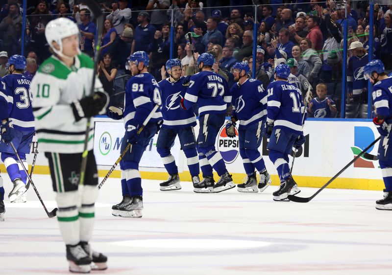 Dec 4, 2023; Tampa, Florida, USA; Tampa Bay Lightning defenseman Victor Hedman (77), defenseman Mikhail Sergachev (98) and teammates celebrate after they beat the Dallas Stars at Amalie Arena. Mandatory Credit: Kim Klement Neitzel-USA TODAY Sports