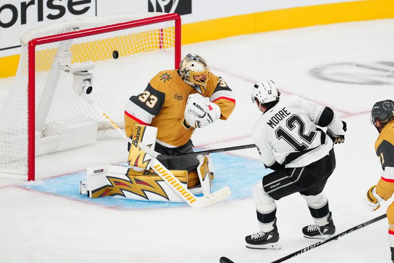 Oct 8, 2025; Las Vegas, Nevada, USA; Los Angeles Kings left wing Trevor Moore (12) scores a goal against Vegas Golden Knights goaltender Adin Hill (33) during the third period at T-Mobile Arena. Mandatory Credit: Stephen R. Sylvanie-Imagn Images