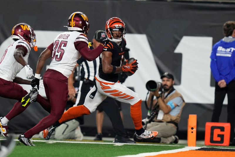 Cincinnati Bengals wide receiver Ja'Marr Chase runs from Washington Commanders safety Percy Butler (35) during a 41-yard touchdown reception in the first half of an NFL football game, Monday, Sept. 23, 2024, in Cincinnati. (AP Photo/Carolyn Kaster)