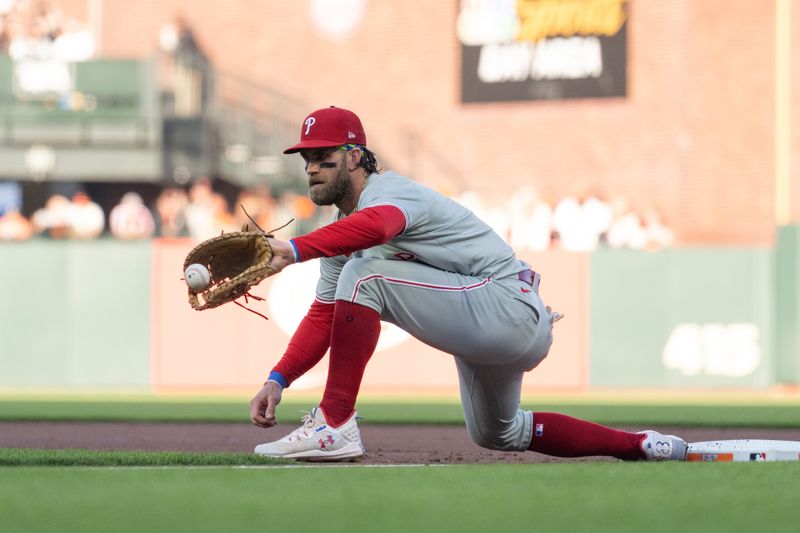 May 28, 2024; San Francisco, California, USA;  Philadelphia Phillies first base Bryce Harper (3) catches the ball during the first inning against the San Francisco Giants at Oracle Park. Mandatory Credit: Stan Szeto-USA TODAY Sports