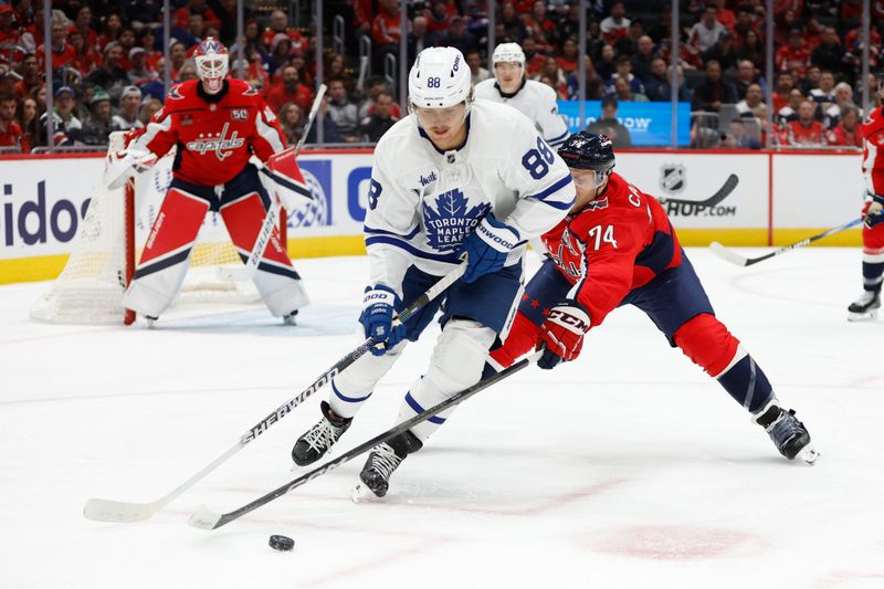 Nov 13, 2024; Washington, District of Columbia, USA; Toronto Maple Leafs right wing William Nylander (88) skates with the puck as Washington Capitals defenseman John Carlson (74) defends in the second period at Capital One Arena. Mandatory Credit: Geoff Burke-Imagn Images
