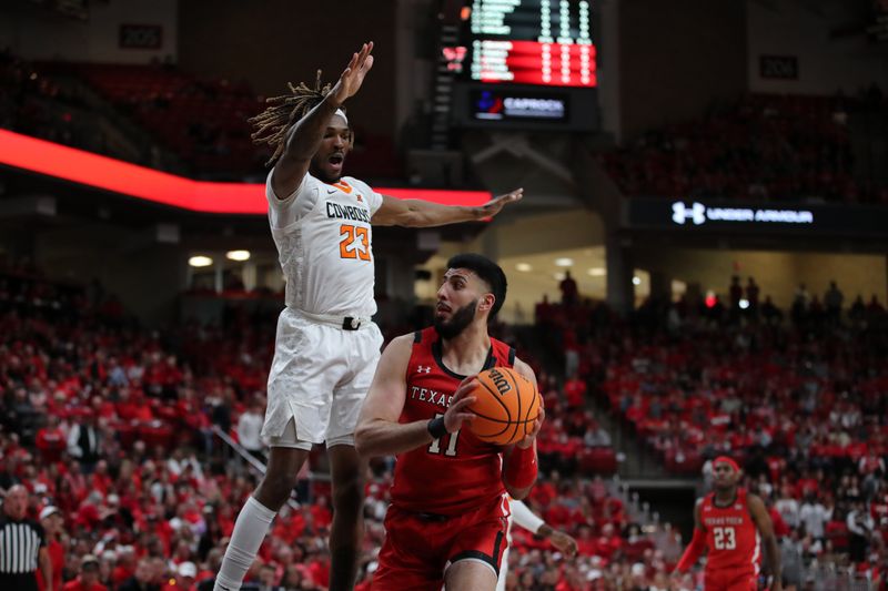 Mar 4, 2023; Lubbock, Texas, USA;  Texas Tech Red Raiders forward Fardaws Aimaq (11) drives against Oklahoma State Cowboys forward Tyreek Smith (23) in the first half at United Supermarkets Arena. Mandatory Credit: Michael C. Johnson-USA TODAY Sports