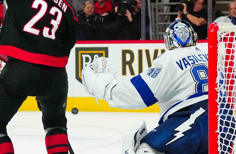 Nov 24, 2023; Raleigh, North Carolina, USA; Tampa Bay Lightning goaltender Andrei Vasilevskiy (88) and Carolina Hurricanes right wing Stefan Noesen (23) watch the shot during the third period at PNC Arena. Mandatory Credit: James Guillory-USA TODAY Sports