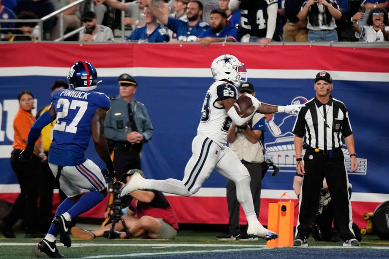 Dallas Cowboys running back Rico Dowdle (23) scores a touchdown against the New York Giants during the first quarter of an NFL football game, Thursday, Sept. 26, 2024, in East Rutherford, N.J. (AP Photo/Bryan Woolston)