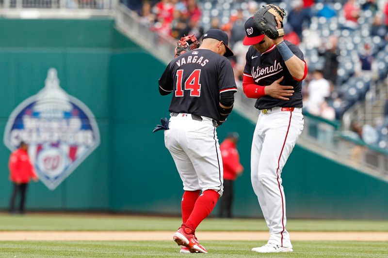 Apr 21, 2024; Washington, District of Columbia, USA; Washington Nationals second base Ildemaro Vargas (14) celebrates with Nationals first base Joey Meneses (45) after the final out against the Houston Astros at Nationals Park. Mandatory Credit: Geoff Burke-USA TODAY Sports