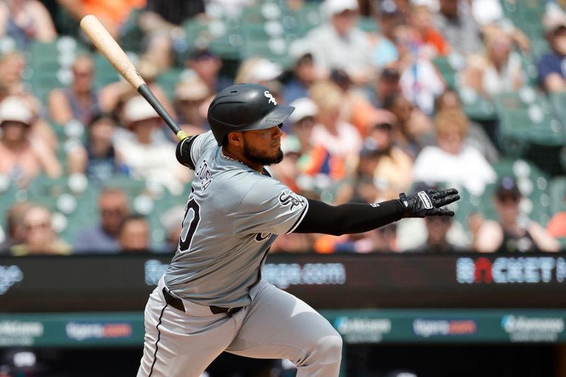 Jun 22, 2024; Detroit, Michigan, USA;  Chicago White Sox third baseman Lenyn Sosa (50) hits an RBI single in the sixth inning against the Detroit Tigers at Comerica Park. Mandatory Credit: Rick Osentoski-USA TODAY Sports