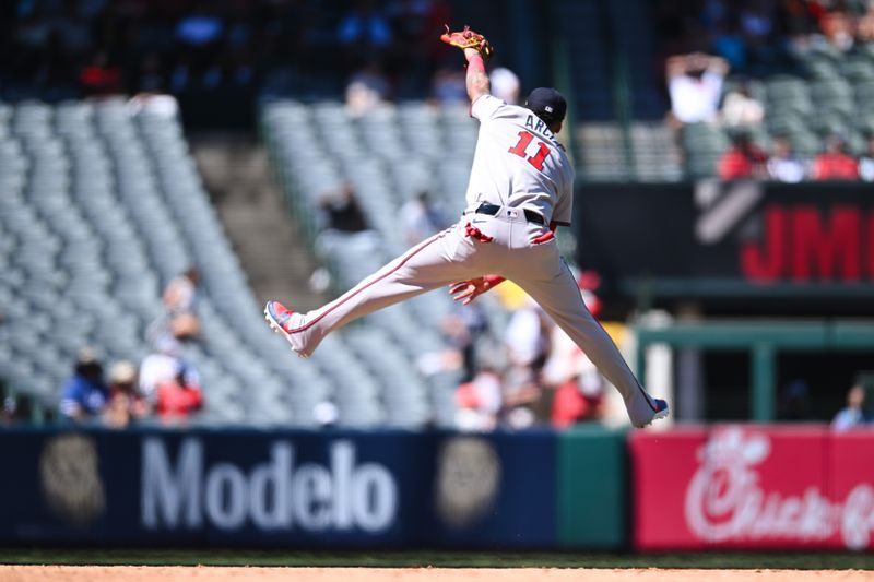Aug 18, 2024; Anaheim, California, USA; Atlanta Braves shortstop Orlando Arcia (11) jumps in the air for a catch against the Los Angeles Angels during the sixth inning at Angel Stadium. Mandatory Credit: Jonathan Hui-USA TODAY Sports