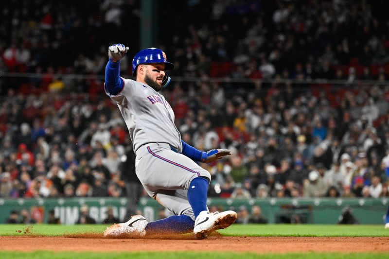 May 21, 2025; Boston, Massachusetts, USA; New York Mets catcher Luis Torrens (13) slides into third base during the seventh inning against the Boston Red Sox at Fenway Park. Mandatory Credit: Eric Canha-Imagn Images
