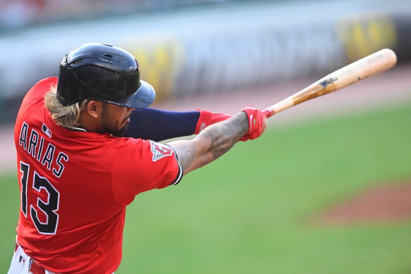 Jul 29, 2025; Cleveland, Ohio, USA; Cleveland Guardians shortstop Gabriel Arias (13) hits a two-run single in the first inning against the Colorado Rockies at Progressive Field. Mandatory Credit: David Richard-Imagn Images