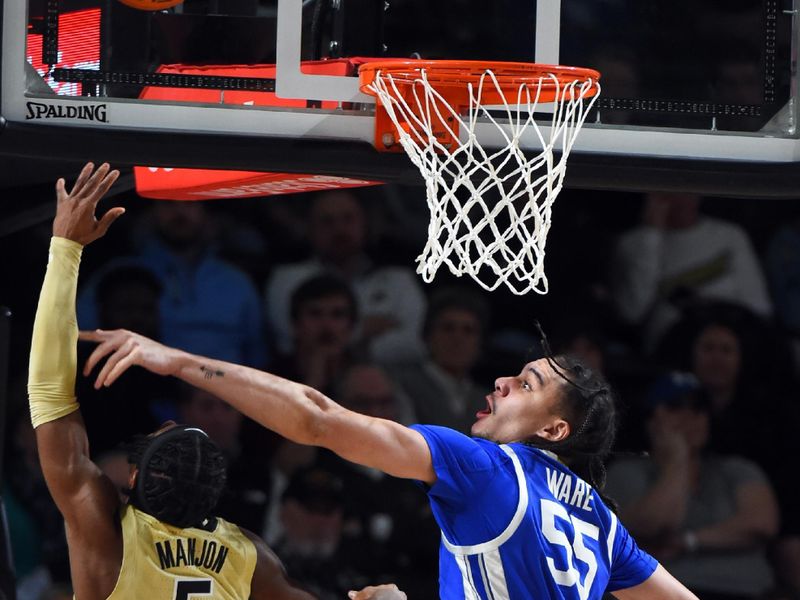 Jan 24, 2023; Nashville, Tennessee, USA; Vanderbilt Commodores guard Ezra Manjon (5) shoots the ball against Kentucky Wildcats forward Lance Ware (55) during the second half at Memorial Gymnasium. Mandatory Credit: Christopher Hanewinckel-USA TODAY Sports