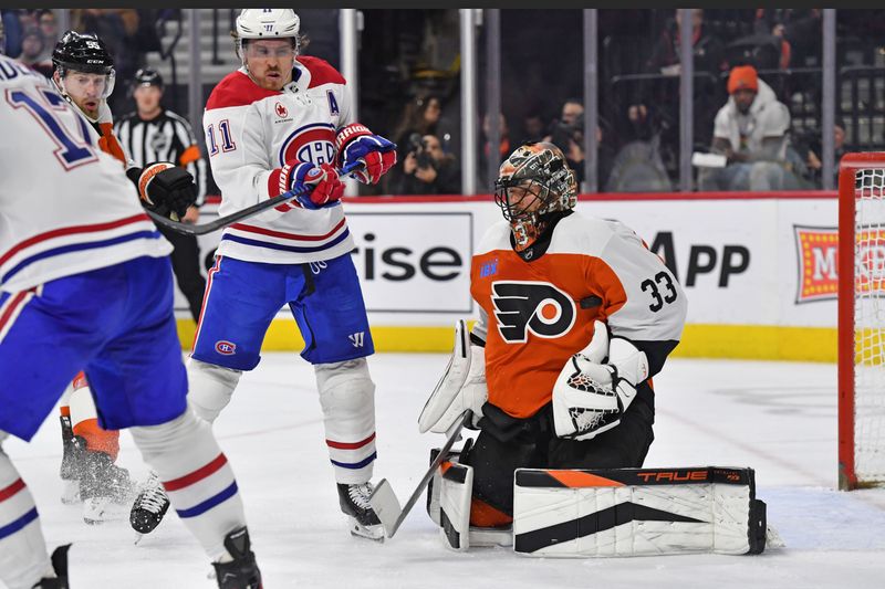 Jan 10, 2024; Philadelphia, Pennsylvania, USA; Philadelphia Flyers goaltender Samuel Ersson (33) makes a save as Montreal Canadiens right wing Brendan Gallagher (11) looks on during the second period at Wells Fargo Center. Mandatory Credit: Eric Hartline-USA TODAY Sports