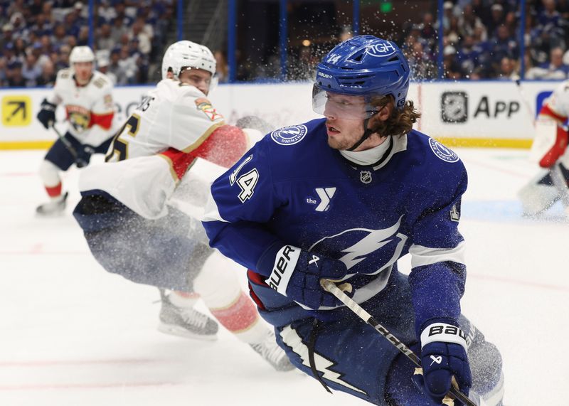 Apr 30, 2025; Tampa, Florida, USA; Tampa Bay Lightning center Conor Geekie (14) skates with the puck against the Florida Panthers during the first period of game five of the first round of the 2025 Stanley Cup Playoffs at Amalie Arena. Mandatory Credit: Kim Klement Neitzel-Imagn Images