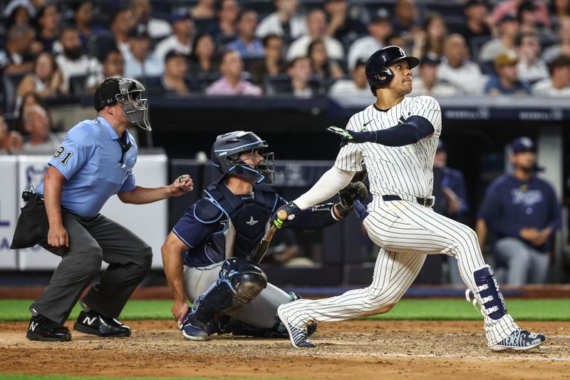 Jul 19, 2024; Bronx, New York, USA;  New York Yankees right fielder Juan Soto (22) hits a double in the sixth inning against the Tampa Bay Rays at Yankee Stadium. Mandatory Credit: Wendell Cruz-USA TODAY Sports