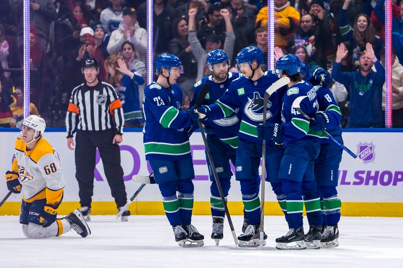 Nov 17, 2024; Vancouver, British Columbia, CAN; Nashville Predators forward Zachary L'Heureux (68) watches as Vancouver Canucks forward Jonathan Lekkerimaki (23) and forward Jake DeBrusk (74) and forward Elias Pettersson (40) and defenseman Quinn Hughes (43) and forward Conor Garland (8) celebrate Pettersson’s goal during the second period at Rogers Arena. Mandatory Credit: Bob Frid-Imagn Images