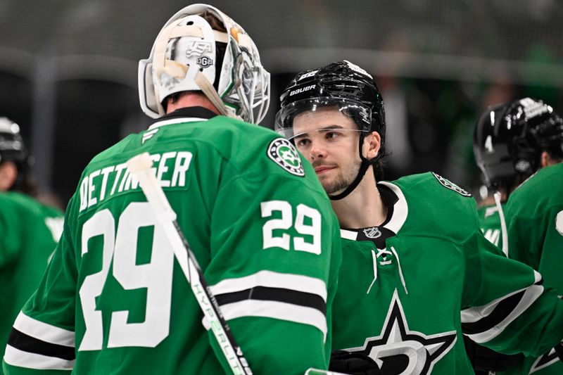 Oct 15, 2024; Dallas, Texas, USA; Dallas Stars goaltender Jake Oettinger (29) and center Mavrik Bourque (22) celebrate the Stars victory over the San Jose Sharks at the American Airlines Center. Mandatory Credit: Jerome Miron-Imagn Images