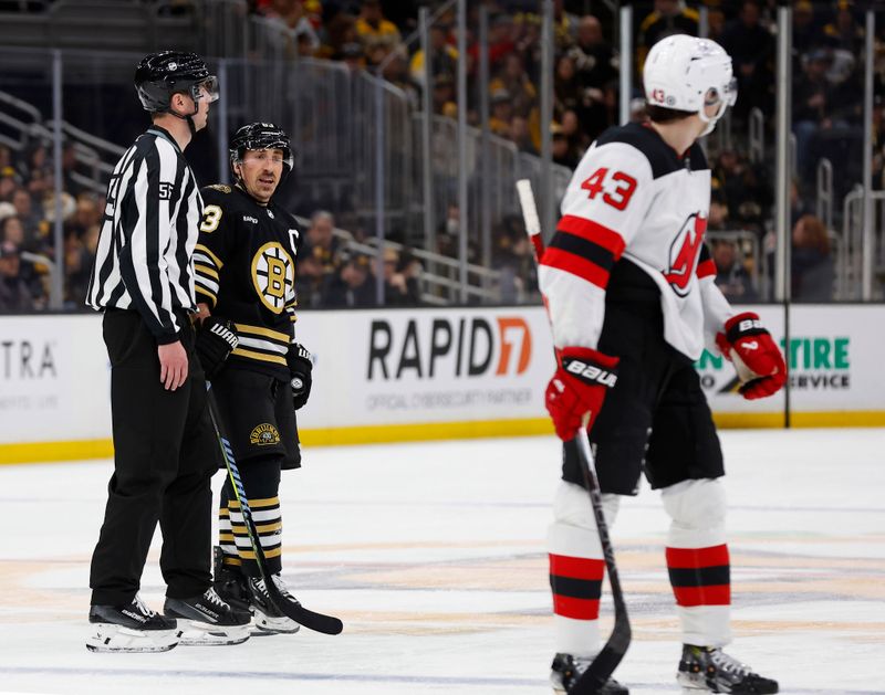 Jan 15, 2024; Boston, Massachusetts, USA; Boston Bruins left wing Brad Marchand (63) has words for New Jersey Devils defenseman Luke Hughes (43) during the third period at TD Garden. Mandatory Credit: Winslow Townson-USA TODAY Sports