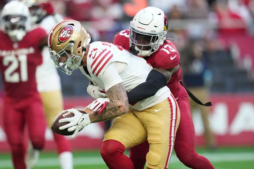 San Francisco 49ers wide receiver Ricky Pearsall (14) catches a touchdown pass against Arizona Cardinals cornerback Kei'Trel Clark (13) during the first half of an NFL football game in Glendale, Ariz., Sunday, Jan. 5, 2025. (AP Photo/Ross D. Franklin)