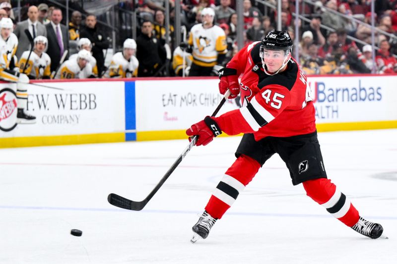 Nov 8, 2025; Newark, New Jersey, USA; New Jersey Devils defenseman Colton White (45) takes a shot on goal against the Pittsburgh Penguins during the second period at Prudential Center. Mandatory Credit: John Jones-Imagn Images