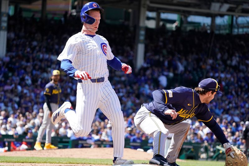 May 5, 2024; Chicago, Illinois, USA; Chicago Cubs outfielder Pete Crow-Armstrong (52) beats out an infield single as Milwaukee Brewers third base Tyler Black (7) takes a late throw during the fifth inning at Wrigley Field. Mandatory Credit: David Banks-USA TODAY Sports