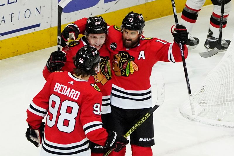 Feb 17, 2024; Chicago, Illinois, USA; Chicago Blackhawks left wing Nick Foligno (17) celebrates his goal with Chicago Blackhawks center Connor Bedard (98) against the Ottawa Senators during the first period at United Center. Mandatory Credit: David Banks-USA TODAY Sports