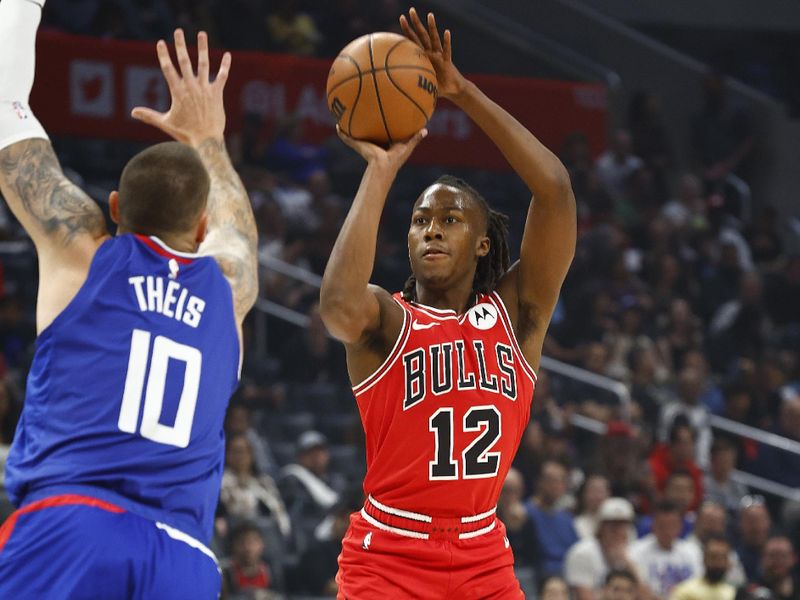 LOS ANGELES, CALIFORNIA - MARCH 09:  Ayo Dosunmu #12 of the Chicago Bulls takes a shot against Daniel Theis #10 of the LA Clippers in the first half at Crypto.com Arena on March 09, 2024 in Los Angeles, California.  NOTE TO USER: User expressly acknowledges and agrees that, by downloading and/or using this photograph, user is consenting to the terms and conditions of the Getty Images License Agreement.  (Photo by Ronald Martinez/Getty Images)