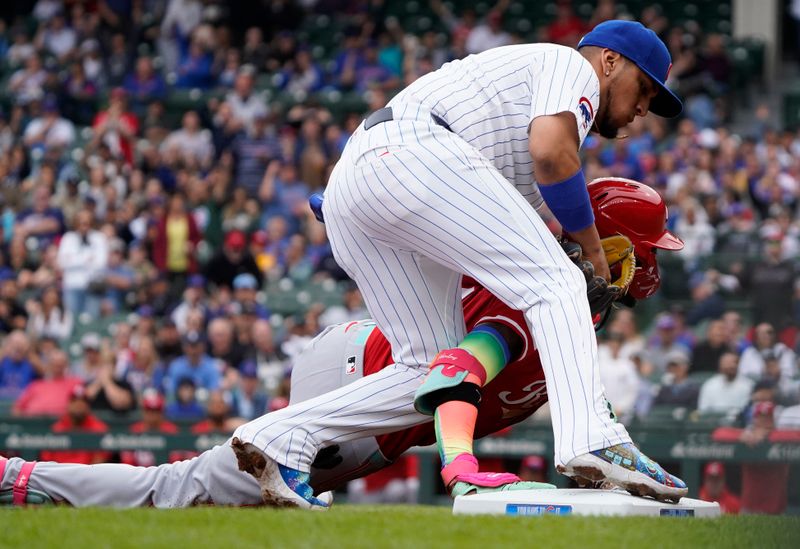 Sep 27, 2024; Chicago, Illinois, USA; Cincinnati Reds shortstop Elly De La Cruz (44) slides into third base and is tagged out by Chicago Cubs third base Isaac Paredes (17) during the first inning at Wrigley Field. Mandatory Credit: David Banks-Imagn Images