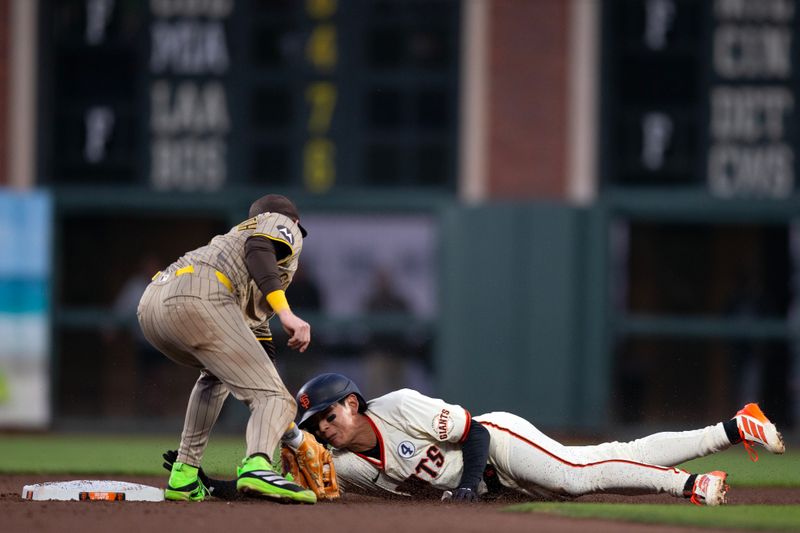 Jun 2, 2025; San Francisco, California, USA; San Francisco Giants center fielder Jung Hoo Lee (51) slides safely past San Diego Padres second baseman Jake Cronenworth (9) with a stolen base during the sixth inning at Oracle Park. Mandatory Credit: D. Ross Cameron-Imagn Images