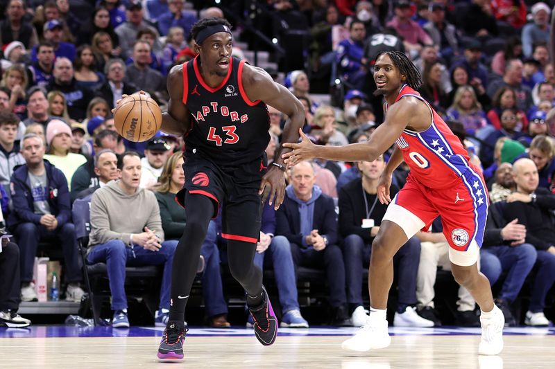 PHILADELPHIA, PENNSYLVANIA - DECEMBER 22: Pascal Siakam #43 of the Toronto Raptors drives past Tyrese Maxey #0 of the Philadelphia 76ers during the first quarter at the Wells Fargo Center on December 22, 2023 in Philadelphia, Pennsylvania. NOTE TO USER: User expressly acknowledges and agrees that, by downloading and or using this photograph, User is consenting to the terms and conditions of the Getty Images License Agreement. (Photo by Tim Nwachukwu/Getty Images)