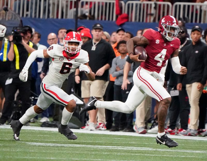 Dec 2, 2023; Atlanta, GA, USA;  Alabama Crimson Tide quarterback Jalen Milroe (4) runs for a first down with Georgia Bulldogs defensive back Daylen Everette (6) pursuing at Mercedes-Benz Stadium. Alabama defeated Georgia 27-24 to claim the SEC Championship. Mandatory Credit: Gary Cosby Jr.-USA TODAY Sports