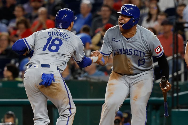 Sep 25, 2024; Washington, District of Columbia, USA; Kansas City Royals catcher Salvador Perez (13) and Royals first baseman Yuli Gurriel (18) celebrate at home plate after scoring runs on a two run single by Royals outfielder Robbie Grossman (not pictured) against the Washington Nationals during the sixth inning at Nationals Park. Mandatory Credit: Geoff Burke-Imagn Images