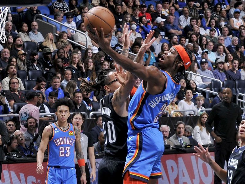 ORLANDO, FL - JANUARY 4: Shai Gilgeous-Alexander #2 of the Oklahoma City Thunder goes to the basket against the Orlando Magic on January 4, 2023 at Amway Center in Orlando, Florida. NOTE TO USER: User expressly acknowledges and agrees that, by downloading and or using this photograph, User is consenting to the terms and conditions of the Getty Images License Agreement. Mandatory Copyright Notice: Copyright 2023 NBAE (Photo by Fernando Medina/NBAE via Getty Images)