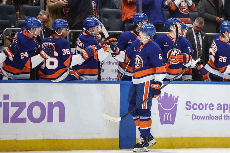 Nov 23, 2024; Elmont, New York, USA;  New York Islanders defenseman Noah Dobson (8) celebrates with his teammates after scoring a goal in the third period against the St. Louis Blues at UBS Arena. Mandatory Credit: Wendell Cruz-Imagn Images