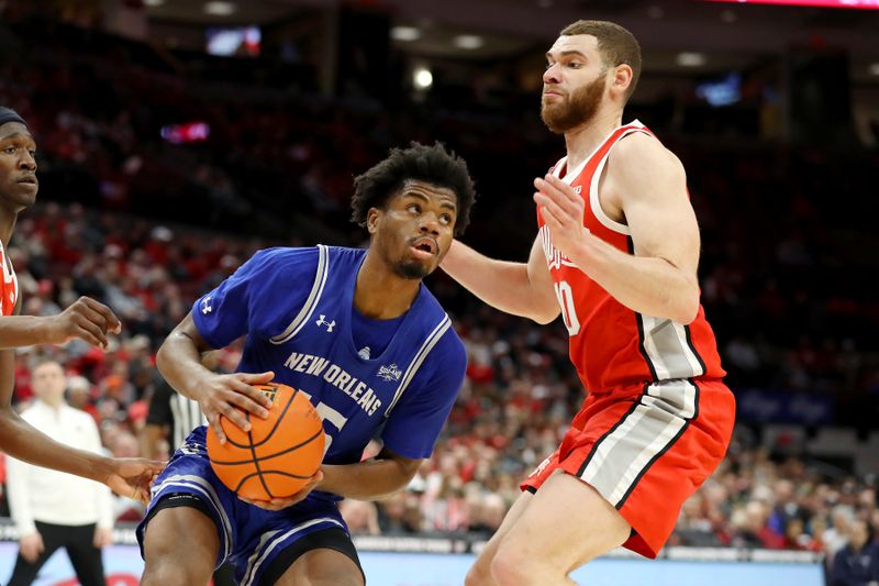 Dec 21, 2023; Columbus, Ohio, USA; New Orleans Privateers guard Carlos Hart (15) looks to score as Ohio State Buckeyes forward Jamison Battle (10) defends during the first half at Value City Arena. Mandatory Credit: Joseph Maiorana-USA TODAY Sports