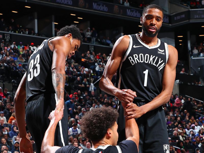 BROOKLYN, NY - JANUARY 23: Cameron Johnson #2 of the Brooklyn Nets is helped up by Mikal Bridges #1 and Nicolas Claxton #33 during the game against the New York Knicks on January 23, 2024 at Barclays Center in Brooklyn, New York. NOTE TO USER: User expressly acknowledges and agrees that, by downloading and or using this Photograph, user is consenting to the terms and conditions of the Getty Images License Agreement. Mandatory Copyright Notice: Copyright 2024 NBAE (Photo by David L. Nemec/NBAE via Getty Images)