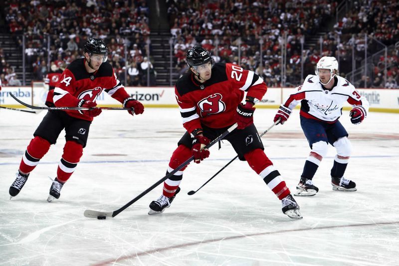 Nov 10, 2023; Newark, New Jersey, USA; New Jersey Devils center Michael McLeod (20) skates with the puck against the Washington Capitals during the second period at Prudential Center. Mandatory Credit: John Jones-USA TODAY Sports