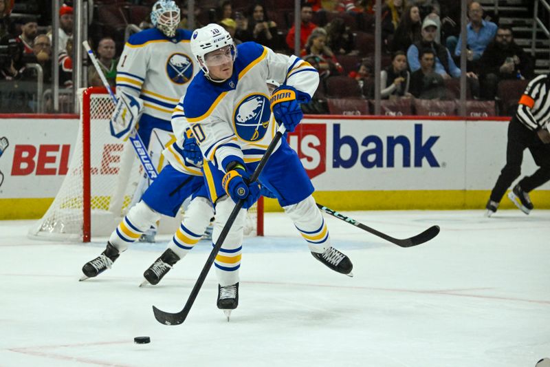 Oct 19, 2024; Chicago, Illinois, USA;  Buffalo Sabres defenseman Henri Jokiharju (10) moves the puck against the Chicago Blackhawks during the first period at the United Center. Mandatory Credit: Matt Marton-Imagn Images