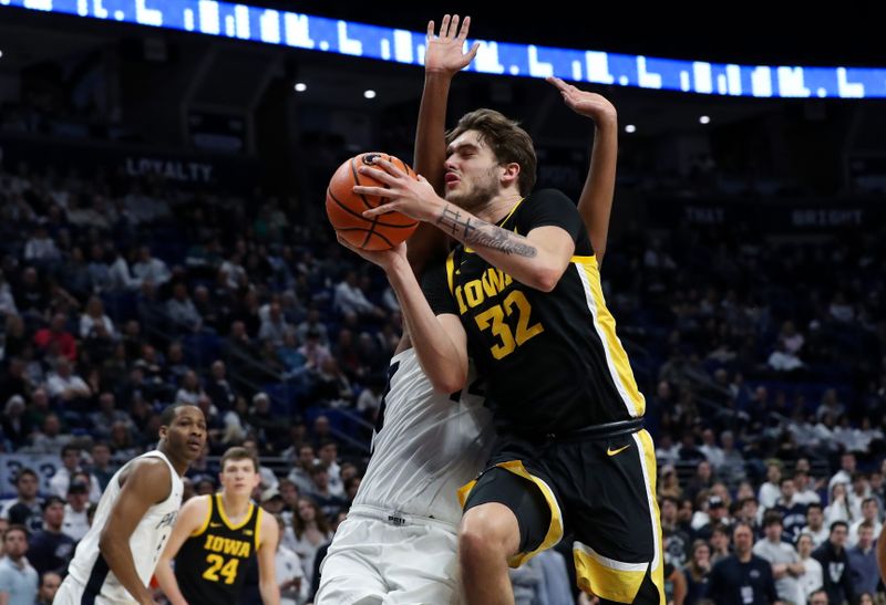 Feb 8, 2024; University Park, Pennsylvania, USA; Iowa Hawkeyes forward Owen Freeman (32) drives the ball to the basket during the second half against the Penn State Nittany Lions at Bryce Jordan Center. Penn State defeated Iowa 89-79. Mandatory Credit: Matthew O'Haren-USA TODAY Sports