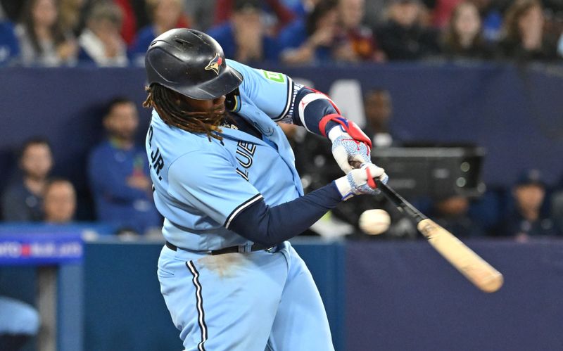 Sep 14, 2023; Toronto, Ontario, CAN;   Toronto Blue Jays first baseman Vladimir Guerrero Jr. (27) strikes out swinging with two men on base in the seventh inning against the Texas Rangers at Rogers Centre. Mandatory Credit: Dan Hamilton-USA TODAY Sports