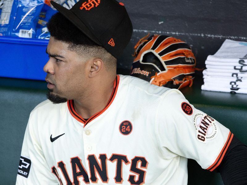 Aug 14, 2024; San Francisco, California, USA; San Francisco Giants first baseman LaMonte Wade Jr. (31) uses a massager on his hip before taking on the Atlanta Braves at Oracle Park. Mandatory Credit: D. Ross Cameron-USA TODAY Sports