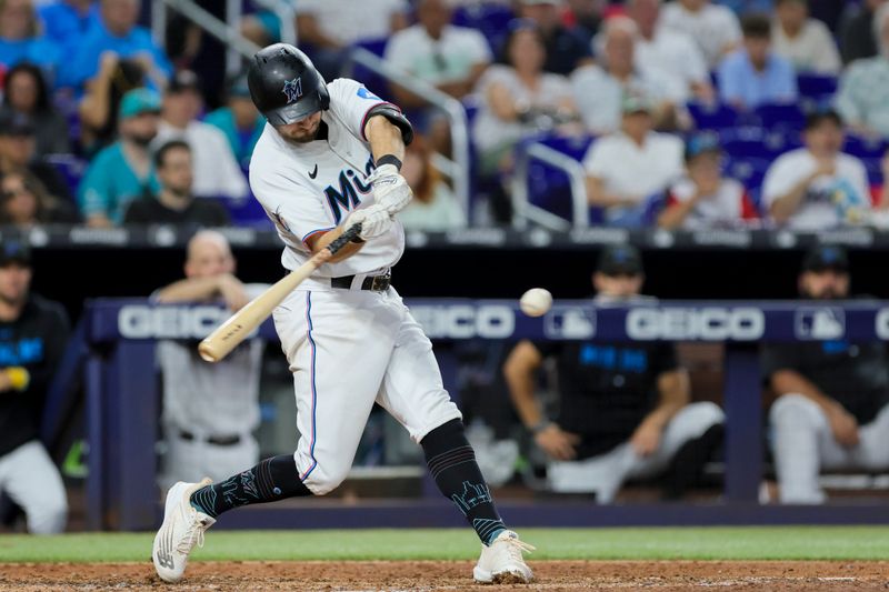 Sep 24, 2023; Miami, Florida, USA; Miami Marlins center fielder Garrett Hampson (1) hits a single against the Milwaukee Brewers during the sixth inning at loanDepot Park. Mandatory Credit: Sam Navarro-USA TODAY Sports