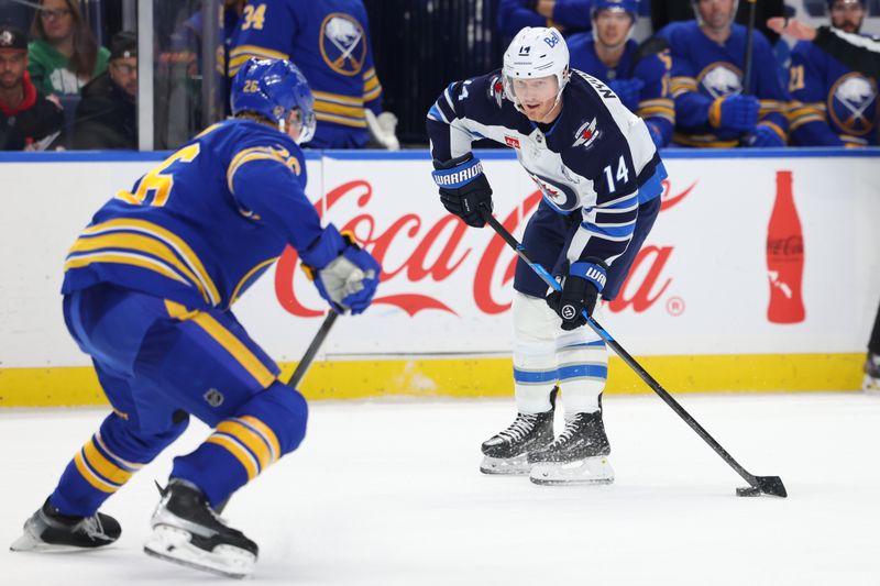 Dec 1, 2025; Buffalo, New York, USA;  Buffalo Sabres defenseman Rasmus Dahlin (26) looks to block a pass by Winnipeg Jets right wing Gustav Nyquist (14) during the third period at KeyBank Center. Mandatory Credit: Timothy T. Ludwig-Imagn Images